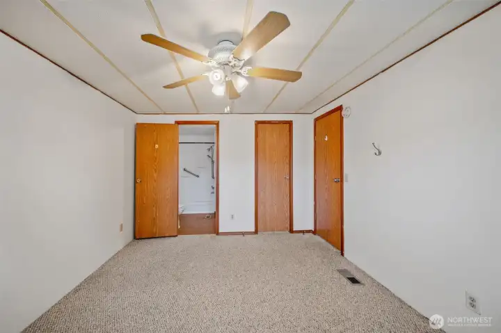 Primary bedroom with door to bathroom and walk in closet Primary bedroom with door to bathroom and walk in closet