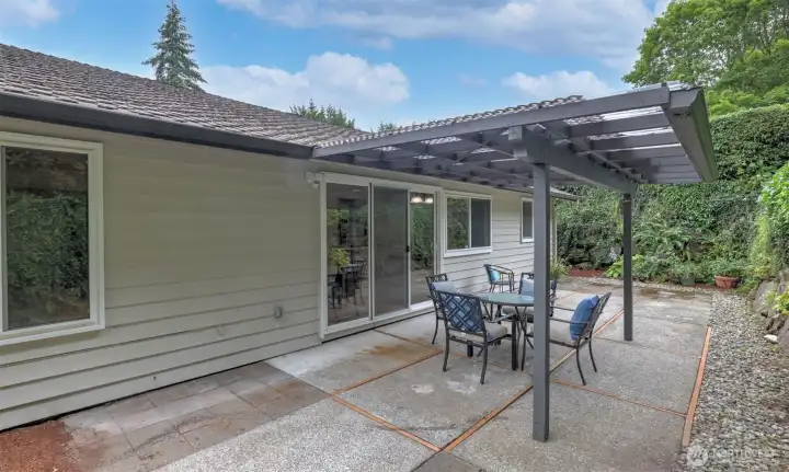 Covered patio overlooking private, mature landscaping—perfect for outdoor dining, entertaining, or relaxing rain or shine. Covered patio overlooking private, mature landscaping—perfect for outdoor dining, entertaining, or relaxing rain or shine.
