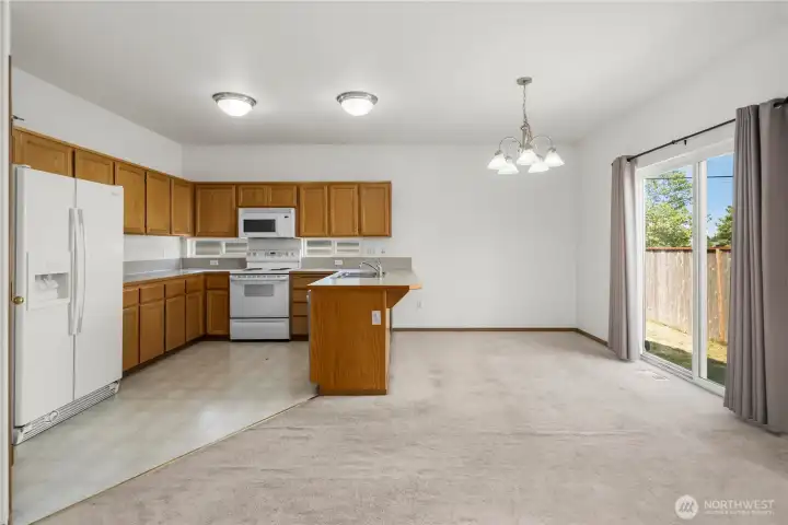 Kitchen and dining room with slider to back patio. Kitchen and dining room with slider to back patio.