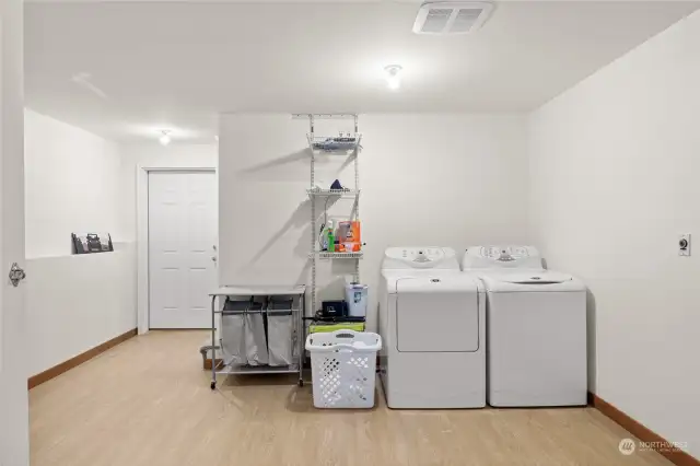 Nice sized laundry space has new LVP flooring, & plenty of space for additional bunks, workout space, or office! This houses the mechanical room & also has an exterior exit.