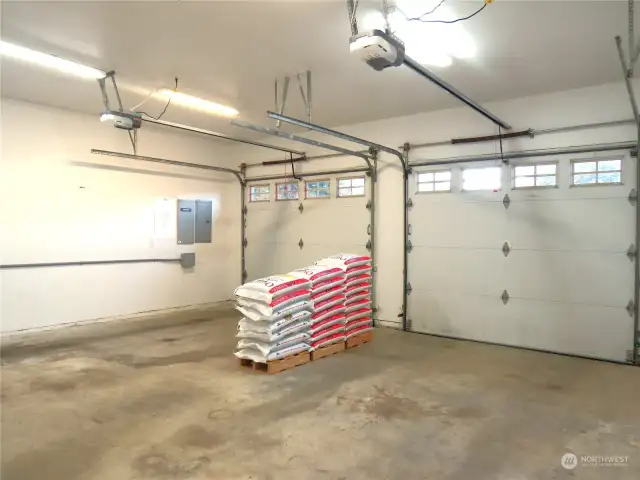 PLENTY OF PARKING IN THIS TWO CAR GARAGE! (NOTE THE PREVIOUS OWNERS LEFT ADDITIONAL PELLETS FOR THE CORNER STOVE IN THE GREAT ROOM)