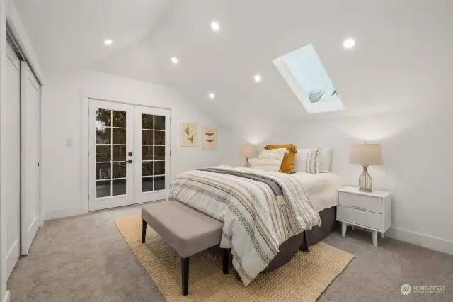 Largest of the three bedrooms on the upstairs level. Wonderful vaulted ceilings, skylight, french doors out to great deck (with access to backyard).