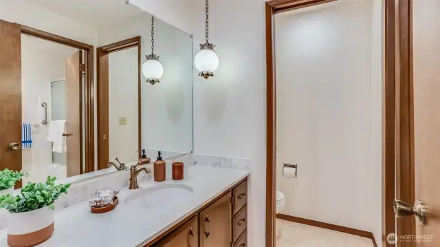 Modern full guest bathroom with sleek finishes, a stylish vanity, and a private water closet.