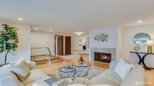 This living room offers a wood burning fireplace and is just steps from the dining room, with plenty of space for hosting.