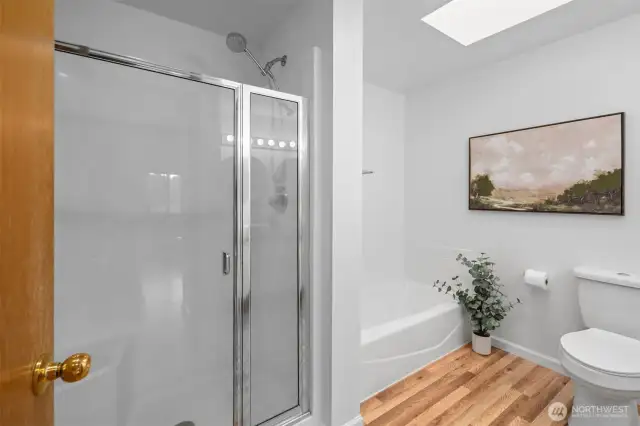 Refreshed ensuite 5 piece bath with oversized shower, soaking tub, and skylight.