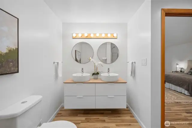 Primary ensuite refreshed bath with double vanity.