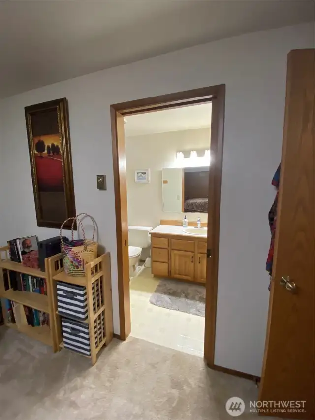From primary, looking into main full bath w pocket door