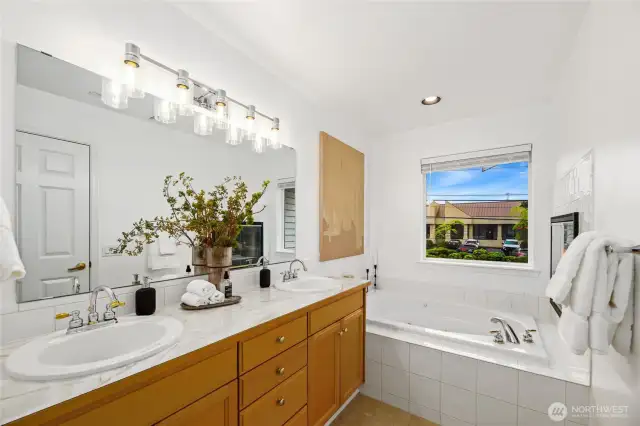 Larger soaking tub in primary bathroom.