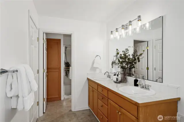 Spacious dual sink vanity with beautiful new lighting. Shower and storage are through the door on the left.