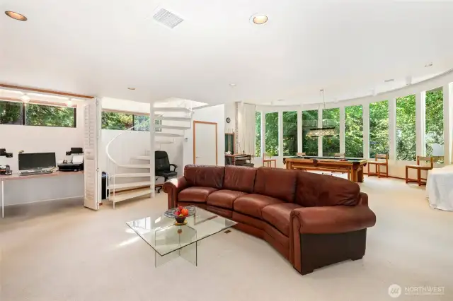 Grand room with windows and pool table.