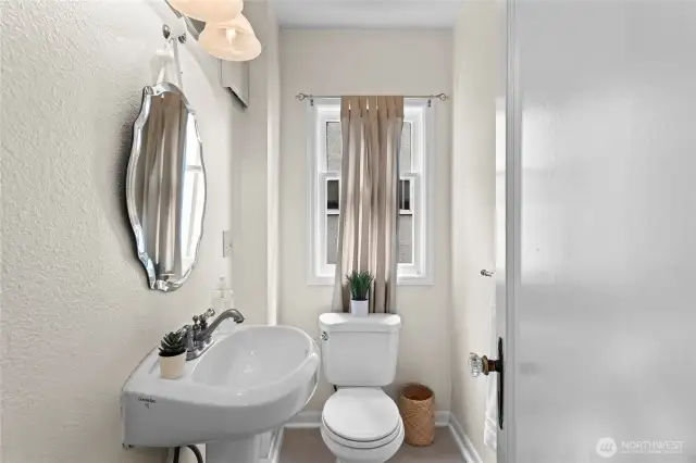 A useful half bath in the hallway between the kitchen and family room