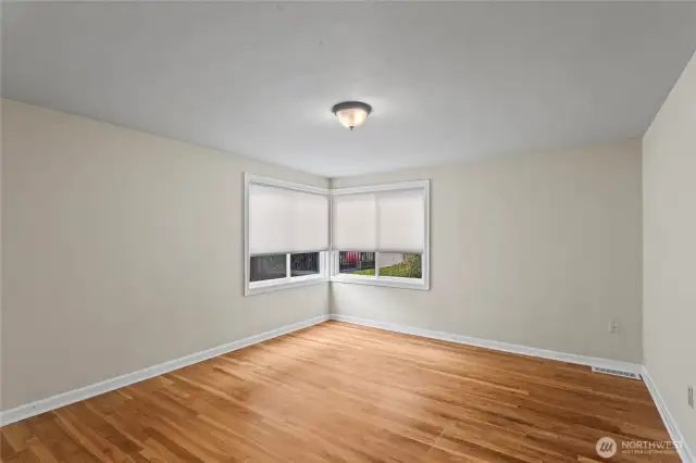 The back bedroom with corner windows and original floors
