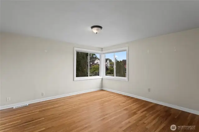 The back bedroom with corner windows and original floors