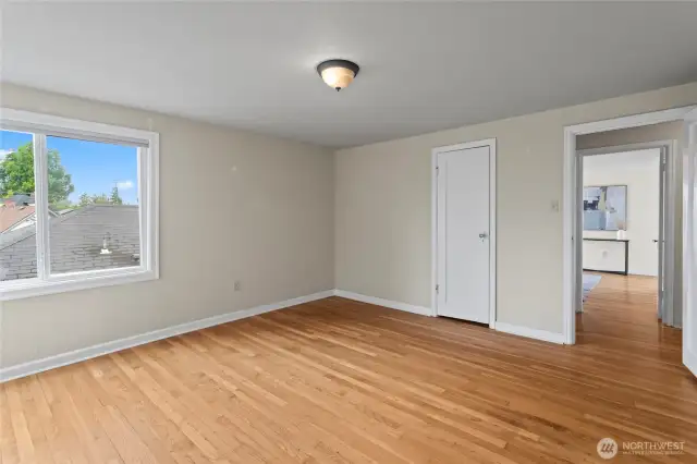 The back bedroom with corner windows and original floors