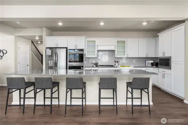 Grand chefs kitchen, with large quartz island! Stainless steal appliances. Fridge to convey.