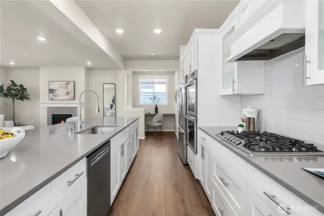 Beauitful LVP lines the luxury kitchen, featuring stainless steal appliances and study nook off of kitchen.