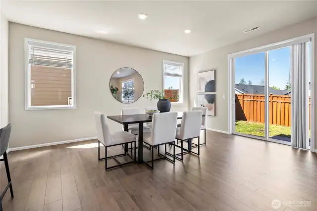 Dining room off of glass slider, flooded with naturall light.