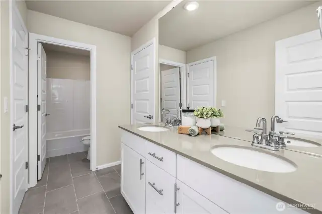 Jack and Jill bathroom with bath tub, shower and quartz counters. Connecting rooms 2 & 3.