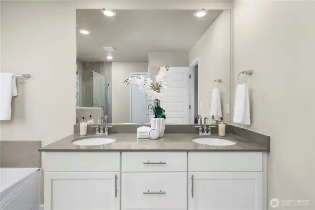 Quartz counter with dual sinks and storage.