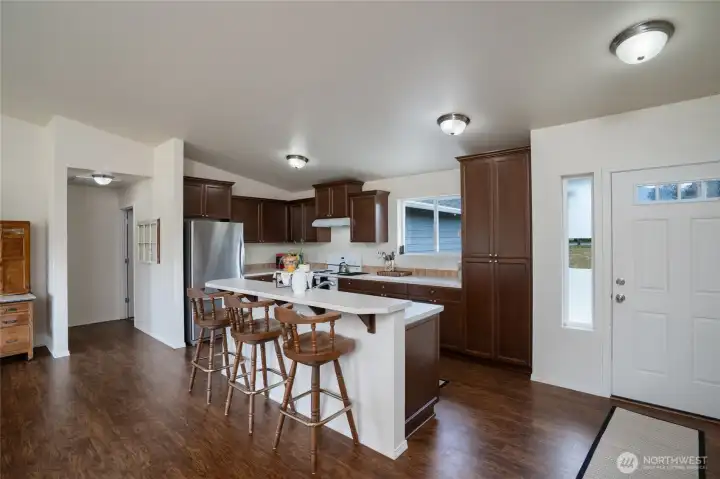 Kitchen with island breakfast bar and seating for three.