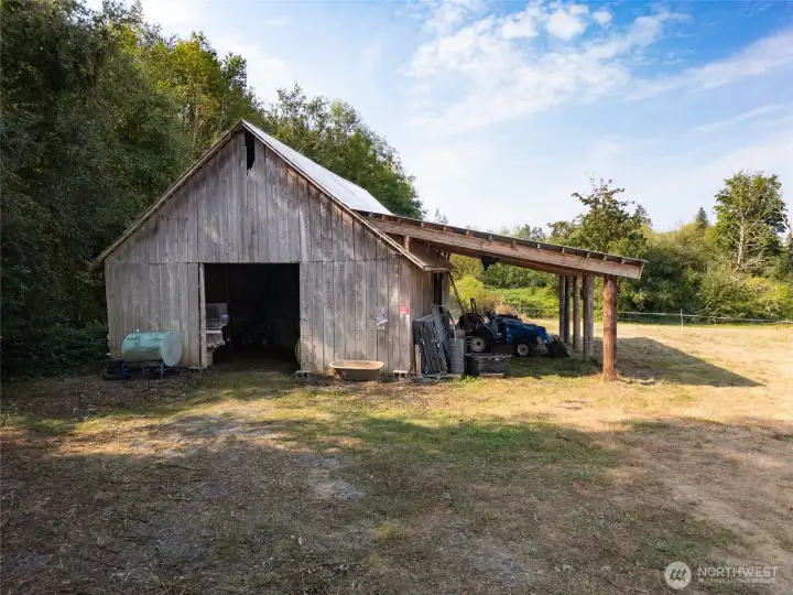 Lean-to off side offers additional covered storage for tractors and implements.