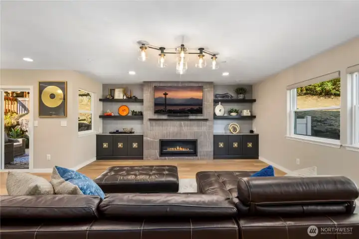 Open space living area with fireplace.