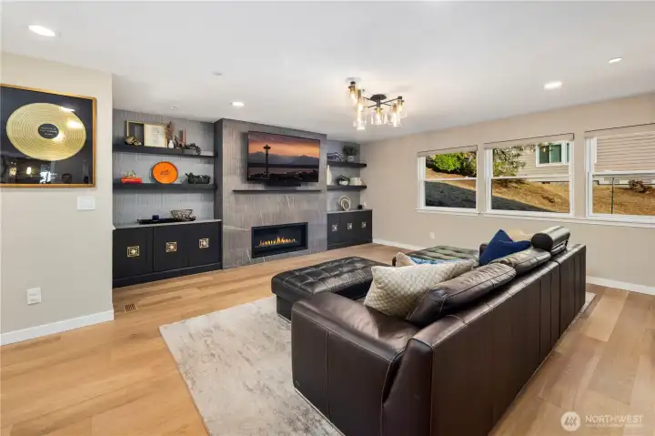 Open space living area with fireplace.