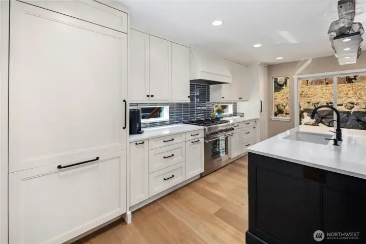 Kitchen with quartz counters, custom soft-close cabitenary, stainless steel appliances and much more.