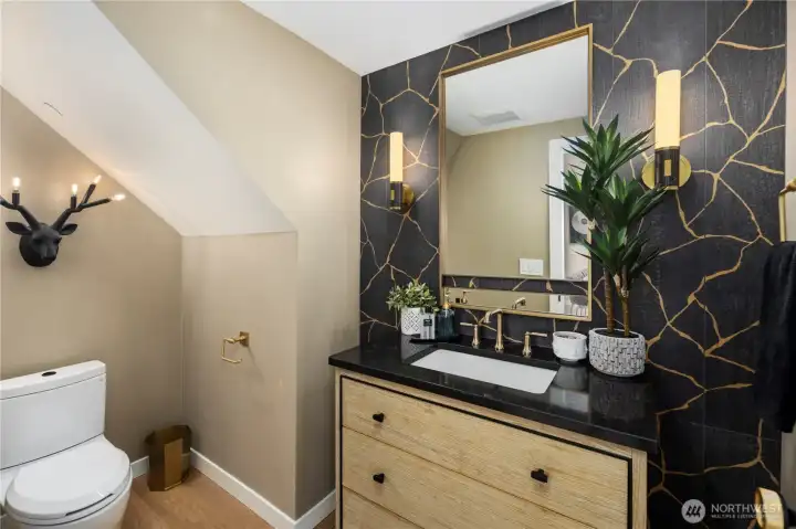 Fully remodeled lower level half bath with designer touches. Tile and textured wall. Every detail, intentional.