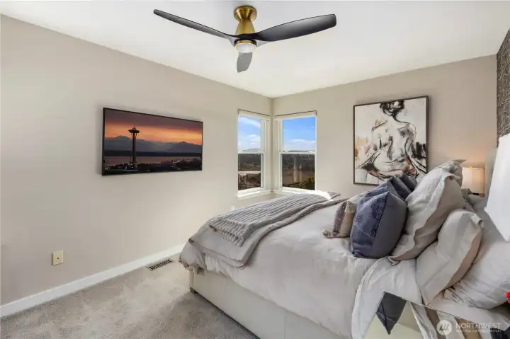 Primary bedroom with mountain and water views.