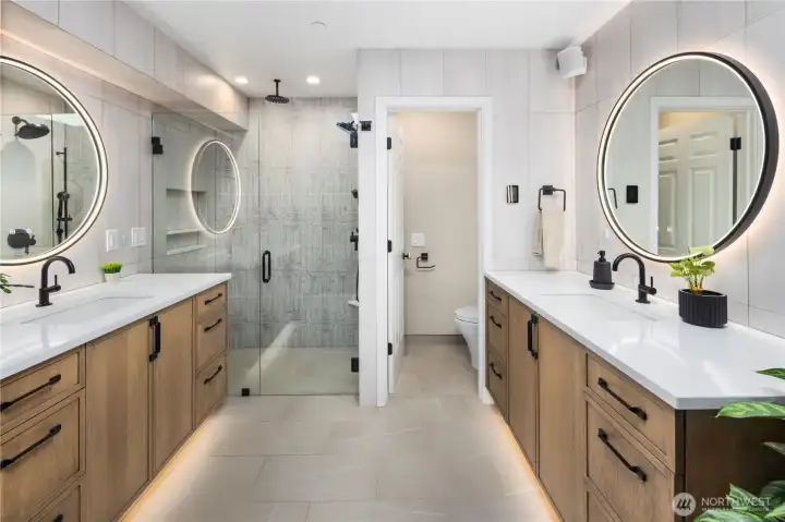 Fully remodeled primary bathroom with heated floors and custom built-in cabinetry