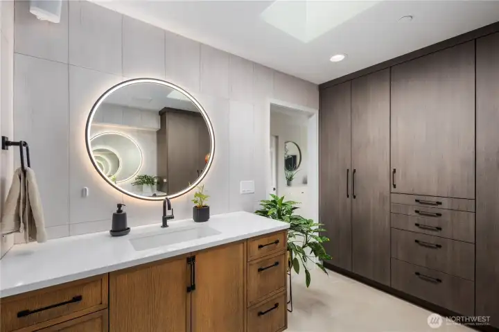 Fully remodeled primary bathroom with heated floors and custom built-in cabinetry