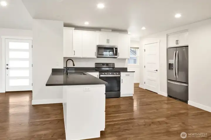 The kitchen features granite counters, stainless steel appliances, and a large pantry—stylish, functional, and ready for everyday living or entertaining.