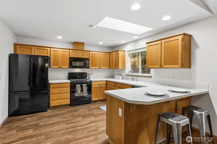 Well laid out kitchen with ample counter space and storage. Kitchen has a skylight and a walk in pantry too.