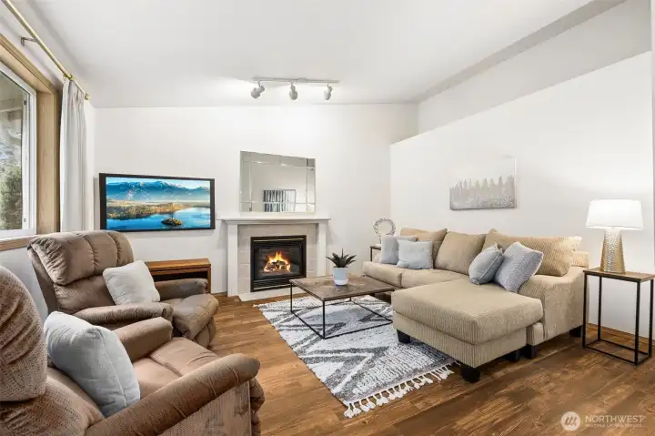 Family room has a gas fireplace, vaulted ceilings and a display ledge.