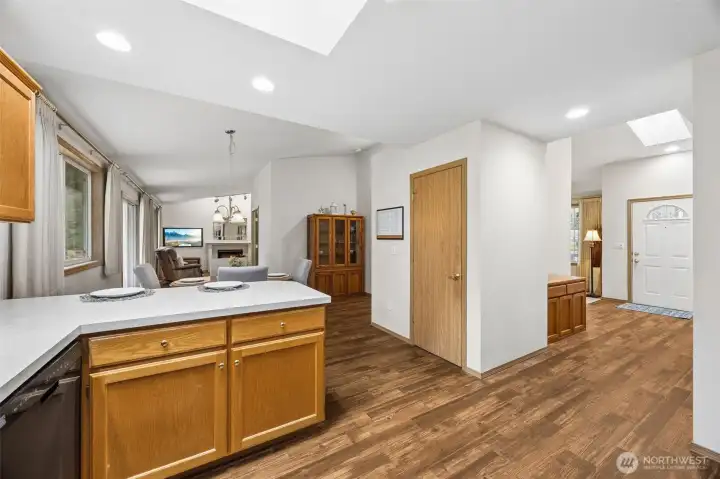View from the farthest corner of the kitchen, looking toward the entry door and the family room.