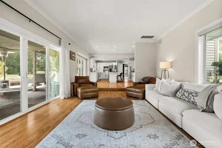 Looking towards the kitchen, this sunken family room is the perfect lounging area.