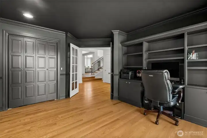 Right next to the kitchen you'll find this color-drenched office with closet and built-ins, could possibly be used as a guest room if desired! There is a sliding door for deck access as well.