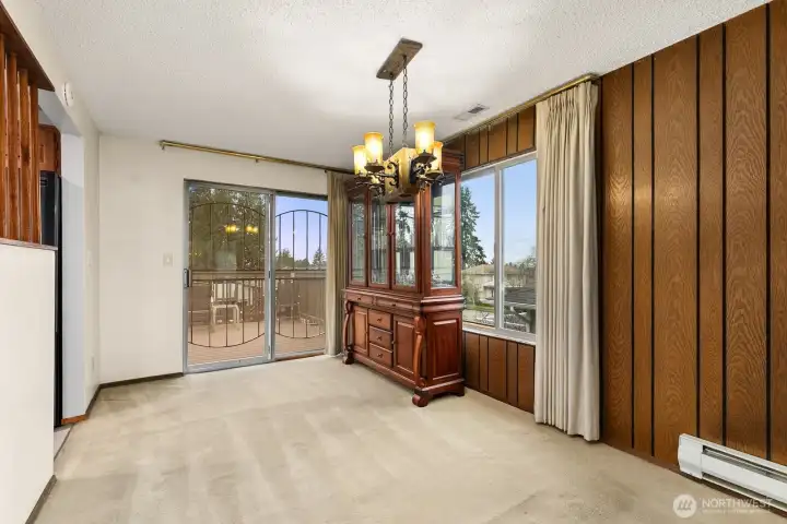 Dining space is adjacent to kitchen and enjoys a view through the sliding doors to the backyard.