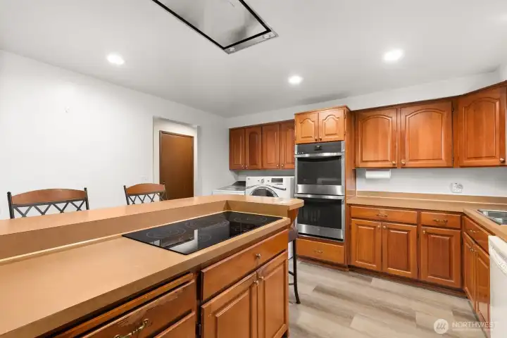 Plenty of counter space, double ovens, stainless steel appliances and overhead vent for stovetop range.