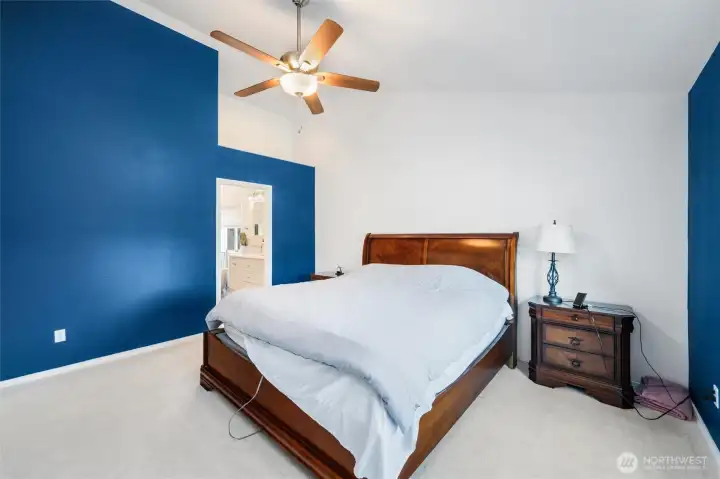 Primary bedroom with view into bath.