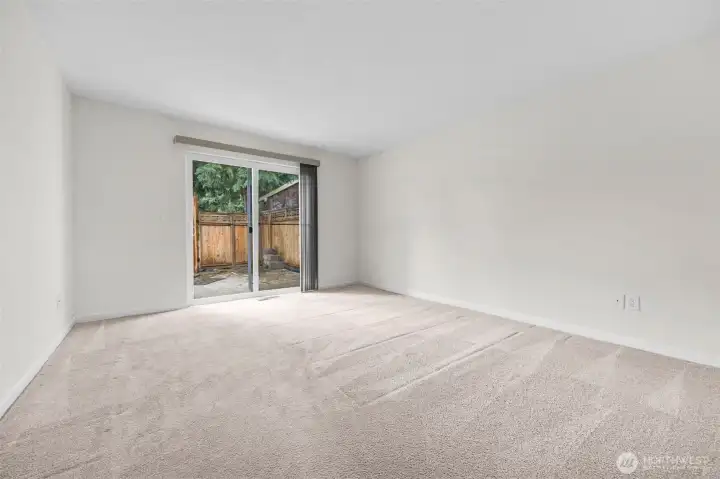 Bedroom with slider to fenced yard