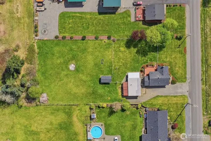 The expansive property features a dedicated half-acre pasture, offering a beautiful canvas for animals, gardens, or future expansion.