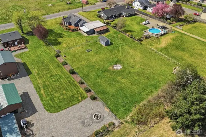 This overhead view highlights the expansive footprint of the property, showcasing the seamless transition from the manicured home site to the open, usable pasture.