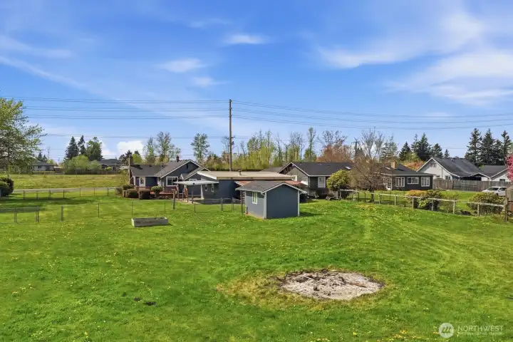 The level topography of the shy-acre lot ensures every square inch is functional, whether you're planning a large-scale garden or a custom outdoor play area.