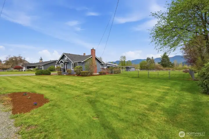 Looking across the dedicated half-acre pasture, you can easily visualize the space for a hobby farm, horses, or a private paddock.