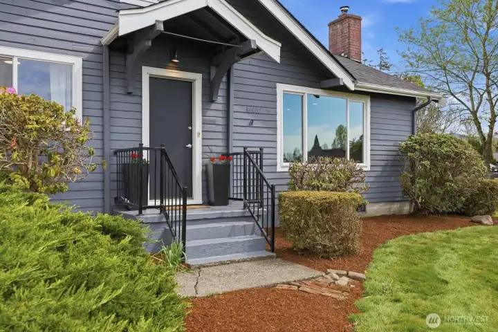 The freshly painted front porch and new garden bark create a welcoming entrance to this quiet rural retreat.
