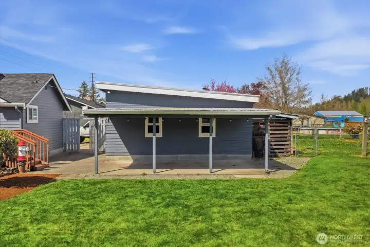 Positioned perfectly for utility and comfort, this sheltered area provides convenient access between the home and the expansive side yard.