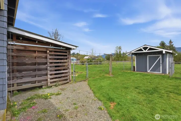 Additional outbuildings, including this shed with a newer roof, provide extra storage and utility for the property.