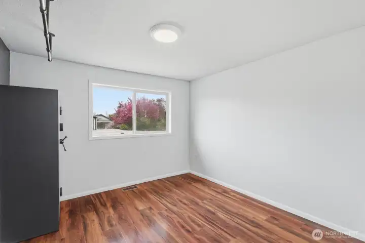 This well-proportioned space provides a blank canvas, perfectly suited for a bedroom, hobby room, or a dedicated workout studio overlooking the property.